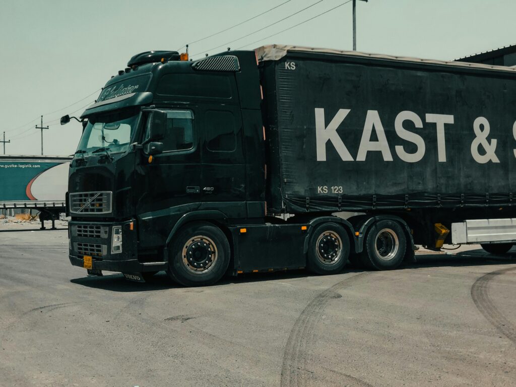 A large industrial truck parked in an urban setting, showcasing transportation industry visuals.